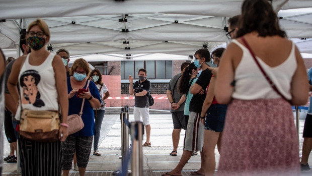 Residents wearing protective face masks queue outside a mass coronavirus screening facility in the Sant Ildefons district of Barcelona, Spain, on Tuesday, Aug. 25, 2020. Spanish Prime Minister Pedro Sanchez rejected calls for a new national lockdown as the nation reemerges as the epicenter of the coronavirus pandemic in Europe. Photographer: Angel Garcia/Bloomberg
