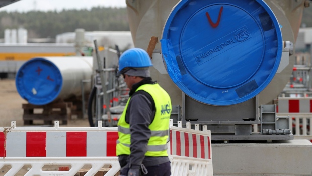 A worker passes a blue Nord Stream 2 branded protective end cap on a section of pipe at the landing site of Nord Stream 2 gas pipeline, operated by Gazprom PJSC, in Lubmin, Germany, on Tuesday, March 26, 2019. Germany is preparing one of its biggest sustained increases in natural gas consumption in almost two decades, regardless of U.S. admonitions that it shouldnt draw so much of its energy from Russia.