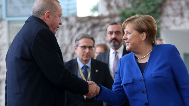 Erdogan pays attention to Germany’s chancellor.