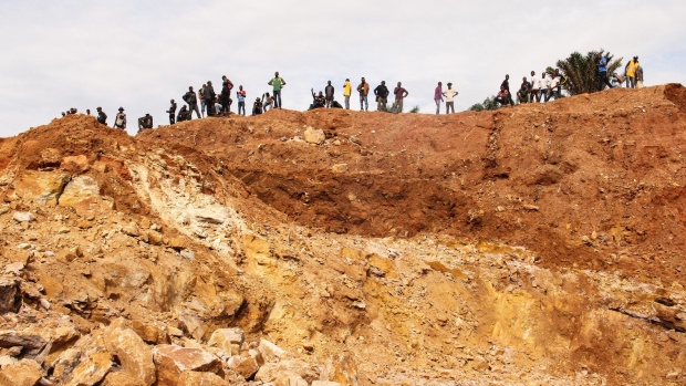 Artisanal miners stand as they wait for safety equipment to arrive and permission to start extracting cobalt on the perimeter of a freshly excavated pit at the Kasulo township in Kolwezi, Democratic Republic of the Congo, on Saturday, Feb. 24, 2018. So-called artisanal mining is as commonplace as farming in many parts of Congo.