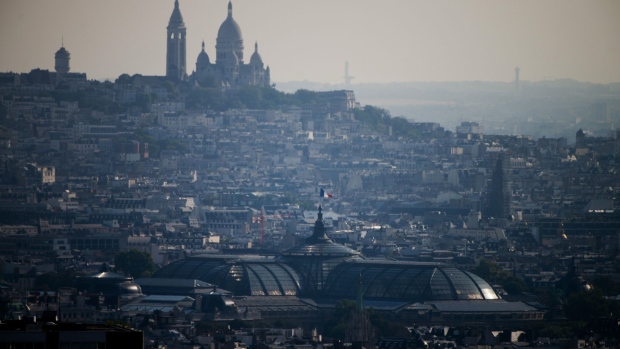 The French national flag flies from the Grand Palais on the city skyline near the Sacre Coeu basilica as viewed from the Generali Baloon hot air research balloon as it carries out air quality checks in Paris, France, on Saturday, July 18, 2020. The French state was scolded by judges for failing to properly tackle air pollution and given a six-month ultimatum to clean up or face millions of euros in fines. Photographer: Nathan Laine/Bloomberg