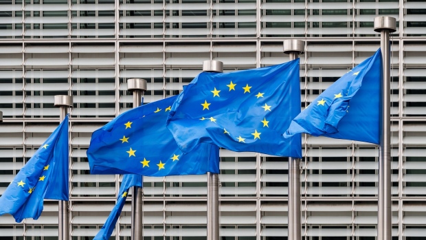 A line of European Union (EU) flags fly from flagpoles outside the Berlaymont building, which houses offices of the European Commission, in Brussels, Belgium, on Monday, June 8, 2020