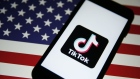 The TikTok logo is displayed in front of an image of the national flag of the U.S. in this arranged photograph in London, U.K., on Monday, Aug. 3, 2020. TikTok has become a flash point among rising U.S.-China tensions in recent months as U.S. politicians raised concerns that parent company ByteDance Ltd. could be compelled to hand over American users’ data to Beijing or use the app to influence the 165 million Americans, and more than 2 billion users globally, who have downloaded it. Photographer: Hollie Adams/Bloomberg