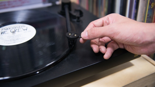 A member of staff plays a vinyl record at the HMV Record Shop operated by Lawson HMV Entertainment Inc. in the Shibuya district of Tokyo, Japan, on Wednesday, Sept. 28, 2016. Spotify Ltd. is bringing its popular online music service to Japan, a large and lucrative market where fans have demonstrated a continuing fondness for CDs and even vinyl records.