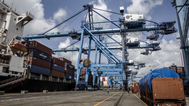 A ship-to-shore crane loads shipping containers onto a cargo vessel docked at Mombasa port, operated by Kenya Ports Authority, in Mombasa, Kenya, on Saturday, Sept. 1, 2018. China's modern-day adaptation of the Silk Road, known as the Belt and Road Initiative, aims to revive and extend trading routes connecting China with Central Asia, the Middle East, Africa and Europe via networks of upgraded or new railways, ports, pipelines, power grids and highways.