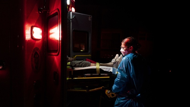 A paramedic wears protective gear while placing a person experiencing Covid-19 related symptoms inside an ambulance in Brooklyn Park, Maryland, U.S., on Wednesday, July 22, 2020. The number of confirmed cases of the coronavirus illness COVID-19 worldwide climbed above 15 million on Thursday and the U.S. case tally edged closer to 4 million. Photographer: Alex Edelman/Bloomberg