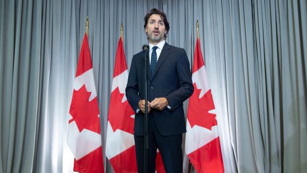 Justin Trudeau speaks with the media before the first day of a Liberal cabinet retreat
