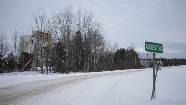 A sign designating the town line stands in Asbestos, Quebec, Canada, on Friday, Feb. 9, 2018. Quebec once produced half of the world's asbestos and offered the highest-paying mining jobs in Canada before concern about cancer led to the fire-resistant fiber being banned in more than 50 countries, with the mine finally shutting down in 2012. But now it turns out that the future of Asbestos may actually be in the millions of tons of discarded residue that piled up over more than a century of mining for the mineral. Photographer: Christinne Muschi/Bloomberg