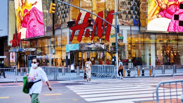 Pedestrians pass in front of a Hennes & Mauritz (H&M) store in New York, U.S., on Monday, June 22, 2020. No city is more important to America’s economic recovery than New York. The economic output of the New York metro area, estimated at $1.8 trillion, rivals that of entire nations. Photographer: Gabby Jones/Bloomberg