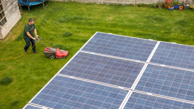 Solar panels which form part of a Lightsource BP smart home solution sit on a flat roof at a residential property in Dorking, U.K., on Friday, May 3, 2019. Companies like Lightsource, in which British oil major BP Plc holds a stake, are trialing smart systems in people’s homes that will that will do everything from generating solar power, storing it and managing consumption. Photographer: Chris Ratcliffe/Bloomberg