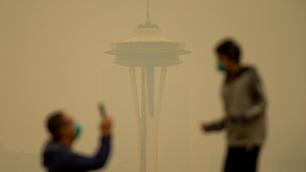 SEATTLE, WA - SEPTEMBER 12: People take photos against the backdrop of the Space Needle as smoke from wildfires fills the air at Kerry Park on September 12, 2020 in Seattle, Washington. According to the National Weather Service, the air quality in Seattle remained at "unhealthy" levels Saturday after a large smoke cloud from wildfires on the West Coast settled over the area. (Photo by Lindsey Wasson/Getty Images)