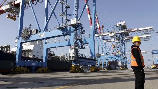 A port worker stands on the quay side near cranes at the Port of Haifa in Haifa, Israel, on Sunday, Nov. 13, 2011. Turkey bought 3 percent of all Israel's exports in the year to August, making the market worth $1.3 billion.