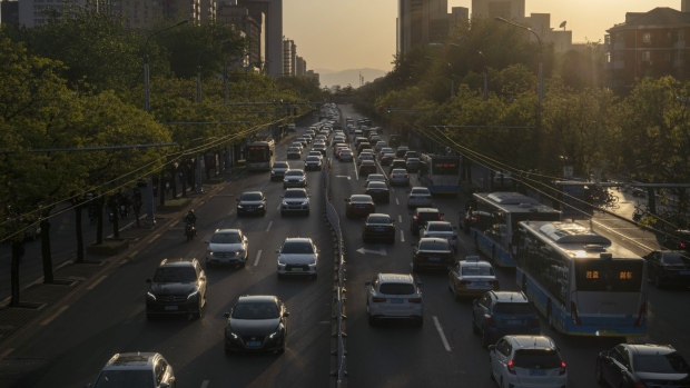 Traffic travel along a road in Beijing, China, on Thursday, April 23, 2020. China's economy will grow by less than 2% in 2020 as the anti-virus shutdowns combine with a collapse in global demand due to the pandemic, according to the latest Bloomberg survey of economists. Photographer: Giulia Marchi/Bloomberg