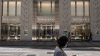 A pedestrian wearing a protective mask walks past a Tiffany & Co. store near Canton Road in the Tsim Sha Tsui district of Hong Kong, China, on Sunday, July 26, 2020. Having briefly shown signs of recovery in recent months from its deepest recession on record, the Asian financial hub is bracing for its stiffest test yet as a resurgent virus combines with an increasingly uncertain political and financial outlook. Photographer: Roy Liu/Bloomberg