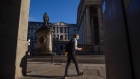 A pedestrian wearing a protective face mask walks past the Bank of England (BOE) in the City of London, U.K., on Tuesday, Aug. 4, 2020. Bank of England officials could signal on Thursday that the case for more monetary stimulus is growing as a nascent rebound from the pandemic-induced recession risks fading.