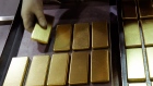 An employee arranges one kilogram gold bars at the Perth Mint Refinery, operated by Gold Corp., in Perth, Australia, on Thursday, Aug. 9, 2018. 
