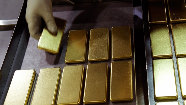 An employee arranges one kilogram gold bars at the Perth Mint Refinery, operated by Gold Corp., in Perth, Australia, on Thursday, Aug. 9, 2018. 
