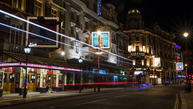 Automobiles leave light trails as they pass theaters in the West End district of London, U.K. on Monday, May 4, 2020. Cabinet Office Minister Michael Gove said the hospitality industry will be the last to see restrictions lifted, as it is the one where it is hardest to maintain social distancing. Photographer: Jason Alden/Bloomberg