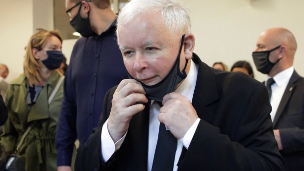 Jaroslaw Kaczynski, chariman of the Law & Justice party (PiS), lowers hi protective face mask as he casts his vote in a polling station Warsaw, Poland, on Sunday, July 12, 2020. Poland goes to the polls today to cast runoff votes in the presidential election.