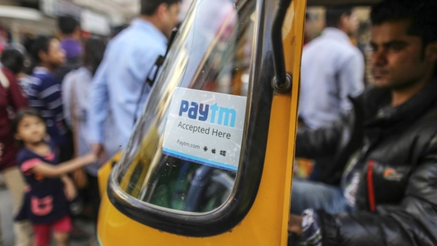 A sign for PayTM online payment method, operated by One97 Communications Ltd., is displayed on the front windscreen of an auto rickshaw in Bengaluru, India, on Saturday, Feb. 4, 2017. A relative laggard in digital transactions, India has more recently seen 50 percent year-on-year growth, according to a study by Google and Boston Consulting Group. The pace may accelerate with demonetization giving digital wallets like Paytm, MobiKwik and Freecharge an extra push. Photographer: Bloomberg/Bloomberg