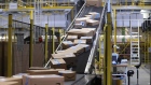 Sealed boxes move along a conveyor into a truck dock ahead of shipping from an Amazon.com Inc. fulfilment center during the online retailer's Prime Day sales promotion day in Koblenz, Germany, on July 15.