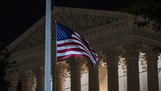 WASHINGTON, DC - SEPTEMBER 18: The national flag flies at half staff as people gather to mourn the passing of Supreme Court Justice Ruth Bader Ginsburg at the steps in front of the Supreme Court on September 18, 2020 in Washington, DC. Ginsburg has died at age 87 after a battle with pancreatic cancer. (Photo by Tasos Katopodis/Getty Images)