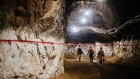 Miners walk through an underground tunnel at a gold mine in South Africa. 