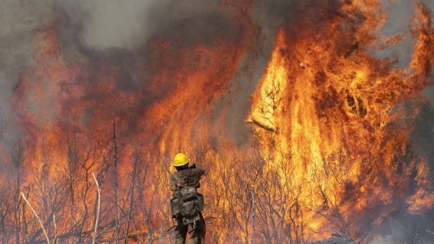A firefighter monitors a controlled burn while fighting the Dolan Fire near Jolon, California, U.S., on Wednesday, Sept. 16, 2020. The wildfire burning in the rugged mountains of California's Big Sur coastline has burned more than 119,488 acres as of Tuesday and is 40% contained, according to the U.S. Forest Service.