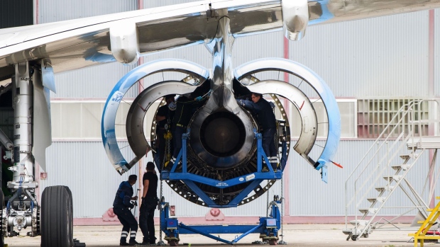Workers carry out maintenance on a turbofan engine, manufactured by Rolls-Royce Holdings Plc, on a grounded passenger aircraft operated by Azul SA at Chateauroux airport in Chateauroux, France, on Thursday, Aug. 27, 2020. The single-runway airport located in France’s flat, central basin has turned away airlines seeking to store more planes -- a sign the global aviation slump is deeply set despite some easing of travel restrictions.