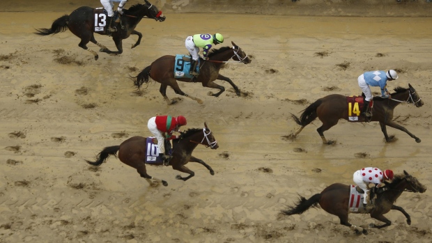 Thoroughbred racehorses cross the finish line during race on the eve of the Kentucky Derby at Churchill Downs in Louisville, Kentucky, U.S., on Friday, May 5, 2017. The 143rd running of the Kentucky Derby will feature a field of twenty horses with the winner receiving a gold trophy plus an estimated $1.24 million payday.