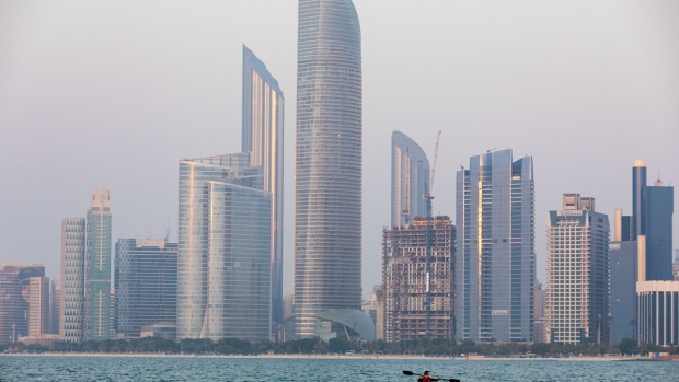 An Emirati woman paddles a canoe past skyscrapers in Abu Dhabi, United Arab Emirates, on Wednesday, Oct. 2, 2019. Abu Dhabi sold $10 billion of bonds in a three-part deal in its first international offering in two years as it takes advantage of relatively low borrowing costs. Photographer: Christopher Pike/Bloomberg