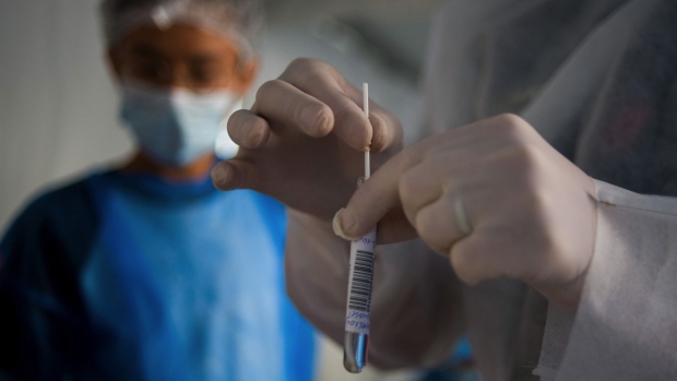 A medic places a Covid-19 swab test into a test tube in Paris, France, on Monday, Sept. 21, 2020. France and the U.K. reported the most new coronavirus cases since May for the second day in a row, underscoring Europe’s risk of a return to lockdowns that crippled the economy in the second quarter. Photographer: Nathan Laine/Bloomberg