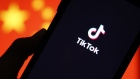 The TikTok logo is displayed on a smartphone in front of the national flag of China in this arranged photograph in London, U.K., on Monday, Aug. 3, 2020.