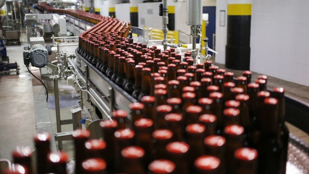 Bottles of beer move along a conveyor belt at the Anheuser-Busch InBev NV Budweiser bottling facility in St. Louis, Missouri.