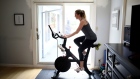 SAN ANSELMO, CALIFORNIA - APRIL 07: Jen Van Santvoord rides her Peloton exercise bike at her home on April 07, 2020 in San Anselmo, California. More people are turning to Peloton due shelter-in-place orders because of the coronavirus (COVID-19). The Peloton stock has continued to rise over recent weeks even as most of the stock market has plummeted. Peloton announced yesterday that they will temporarily pause all live classes until the end of April because an employee tested positive for COVID-19. (Photo by Ezra Shaw/Getty Images) Photographer: Ezra Shaw/Getty Images North America