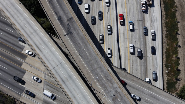 Vehicles move along the Interstate 405 freeway during rush hour in this aerial photograph taken over the Westwood neighborhood of Los Angeles, California, U.S., on Friday, July 10, 2015. The greater Los Angeles region routinely tops the list for annual traffic statistics of metropolitan areas for such measures as total congestion delays and congestion delays per peak-period traveler. Photographer: Bloomberg/Bloomberg