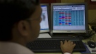 A trader works at a desk in the offices of The Calcutta Stock Exchange Ltd. (CSE) in Kolkata, India, on Wednesday, Feb. 8, 2012. The Indian economy will probably expand 6.9 percent in the year ending in March, the government said on Feb. 7, less than the median estimate of 7 percent in a Bloomberg News survey. Photographer: Brent Lewin