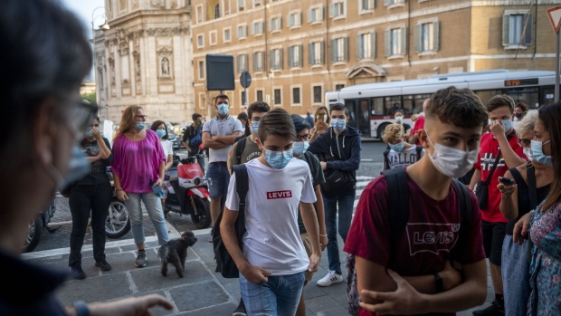 ROME, ITALY - SEPTEMBER 14: Students wearing face masks and keeping their social distance arrive at Newton scientific high during the first day of classes after pandemic related closure, on September 14, 2020 in Rome, Italy. Today millions of Italian students go back to the school after six months at home, with new rules like social distance, protective face masks, outdoor classes and a ban on singing. Like other European countries, Italy has seen an increase in reported COVID-19 cases amid summer travel and easing lockdown measures. (Photo by Antonio Masiello/Getty Images)