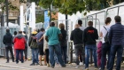 Visitors stand in line at a coronavirus walk-in testing center in Edmonton, in the Enfield district of London on Sept. 23. Photographer: Simon Dawson/Bloomberg