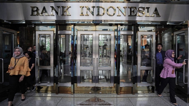 People exit the Bank Indonesia headquarters in Jakarta, Indonesia, on Thursday, April 25, 2019. Indonesia’s central bank left its benchmark interest rate unchanged for a fifth month amid a renewed focus on boosting growth in Southeast Asia’s biggest economy.