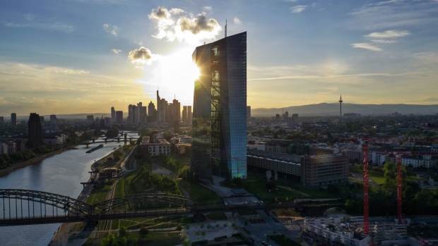 The setting sun reflects off the European Central Bank (ECB) headquarters on the bank of the River Main in this aerial photograph in Frankfurt, Germany, on Tuesday, April 28, 2020. The ECB’s response to the coronavirus has calmed markets while setting it on a path that could test its commitment to the mission to keep prices stable. Photographer: Alex Kraus/Bloomberg