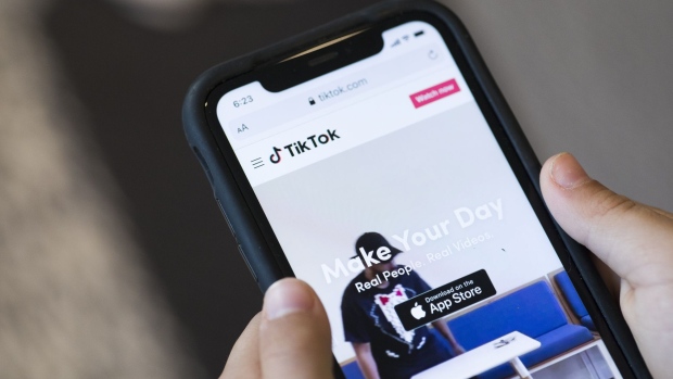 A website for ByteDance Ltd.'s TikTok app is arranged for a photograph on a smartphone in Sydney, New South Wales, Australia, on Monday, Sept. 14, 2020. Oracle Corp. is the winning bidder for a deal with TikTok’s U.S. operations, people familiar with the talks said, after main rival Microsoft Corp. announced its offer for the video app was rejected. Photographer: Brent Lewin/Bloomberg