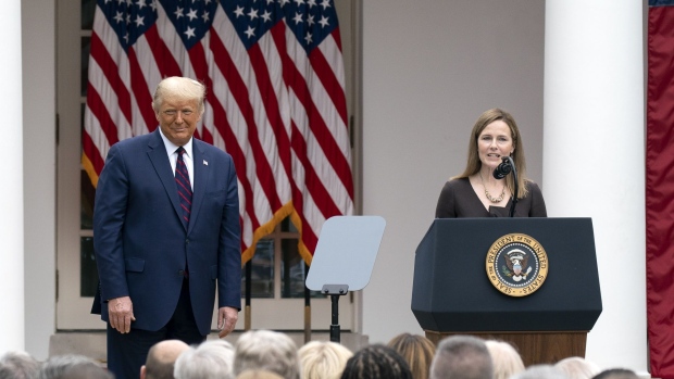 Amy Coney Barrett, U.S. President Donald Trump's nominee for associate justice of the U.S. Supreme Court, center, speaks as President Donald Trump listens during an announcement ceremony in the Rose Garden of the White House in Washington, D.C., U.S., on Saturday, Sept. 26, 2020. Trump said he’ll nominate Judge Amy Coney Barrett for the Supreme Court, adding his third justice to the bench and a fresh jolt to his faltering campaign just weeks before Americans vote on whether to give him a second term.