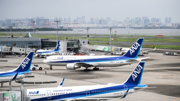 All Nippon Airways Co. (ANA) aircraft stand on the tarmac at Haneda Airport in Tokyo, Japan, on Tuesday, July 28, 2020. Concern over the virus situation in Japan in growing as cases have surged in recent weeks. An outbreak initially thought confined to nighttime entertainment areas in Tokyo has spread to workplaces and across the country. Photographer: Noriko Hayashi/Bloomberg