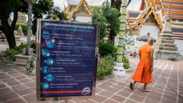 A Covid-19 information sign stands at a near-empty Wat Pho in Bangkok, Thailand, on Wednesday, Sept. 2, 2020. Thailand has reported zero locally-transmitted Covid-19 cases for 100 days in a row, joining a small group of places like Taiwan where the pathogen has been virtually eliminated. Photograph: Taylor Weidman/Bloomberg Photographer: Taylor Weidman/Bloomberg
