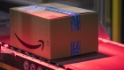 Packed boxes pass along a conveyor belt at the Amazon.com Inc. fulfilment centre in Tilbury, U.K. on Friday, July 12, 2019. 