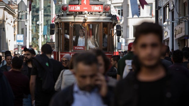 A tram moves along the crowded Istiklal Street in the Beyoglu district of Istanbul, Turkey on Wednesday, Oct. 9, 2019. The lira hovered near its lowest level since late August against the dollar while stocks and government bonds fell as the threat of U.S. penalties mounted after a Turkish military operation in northeast Syria got underway. Photographer: Kerem Uzel/Bloomberg