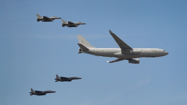 An Airbus A330 Multi Role Tanker Transport (MRTT), right, and other fighter jets perform maneuvers at the Seoul International Aerospace & Defense Exhibition at Seoul Air Base in Seongnam, South Korea, on Oct. 14, 2019.