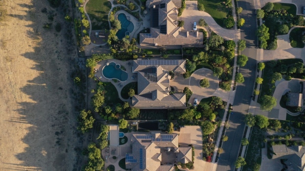 Single-family homes with rooftop solar panels and backyard pools are seen in this aerial photograph taken over a Lennar Corp. development in San Diego, California, U.S., on Tuesday, Sept. 1, 2020. U.S. sales of previously owned homes surged by the most on record in July as lower mortgage rates continued to power a residential real estate market that’s proving a key source of strength for the economic recovery. Photographer: Bing Guan/Bloomberg