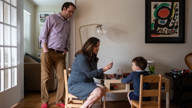 Nancy Weindruch and husband Bruce Nilson play with their son William at home in Arlington, Virginia. Photographer: Cheriss May/Bloomberg